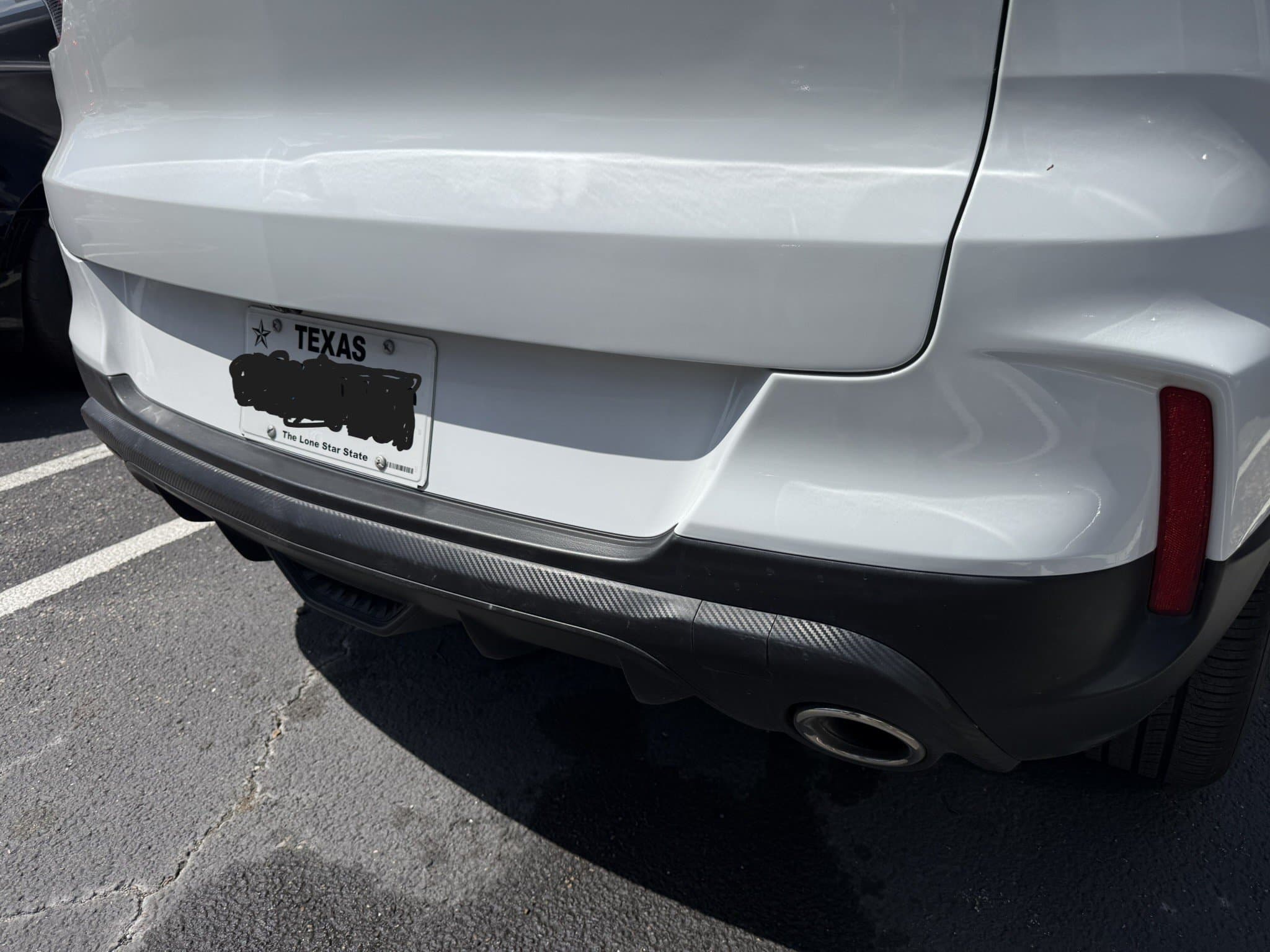 After: Before and after liftgate dent and rear bumper repair on white 2025 Chevrolet Trailblazer RS in Austin TX