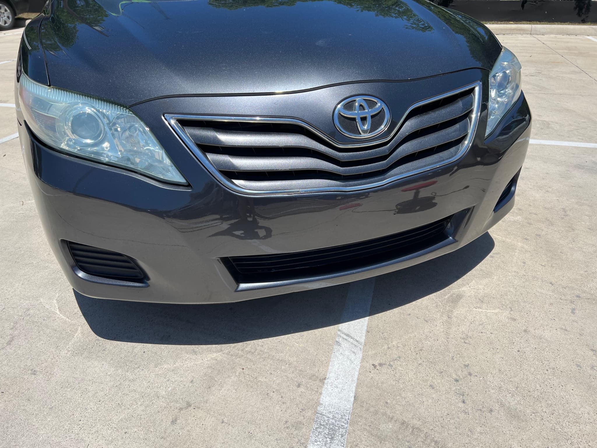 After: Before and after Toyota Camry front bumper repair and headlight restoration in Austin TX